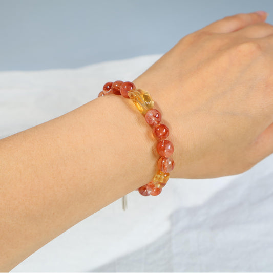 The bracelet made of red inclusion crystal and citrine ignites good luck and attracts blessings.  C042D